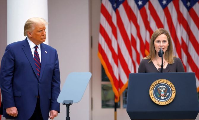 US President Donald Trump watches US Court of Appeals for the Seventh Circuit Judge Amy Coney Barrett deliver remarks as he holds an event to announce her as his nominee to fill the Supreme Court seat left vacant by the death of Justice Ruth Bader Ginsburg at the White House in Washington. Photograph: Carlos Barria/Reuters